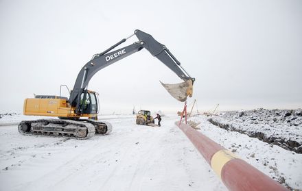 A digger on a pile of earth.