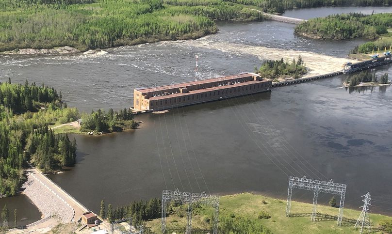 Floodwaters surround roads and the hydroelectric generating station.