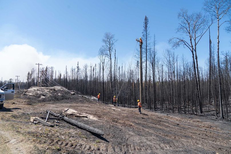 Manitoba Hydro crews work to restore power in the aftermath of fires in Eastern Manitoba.