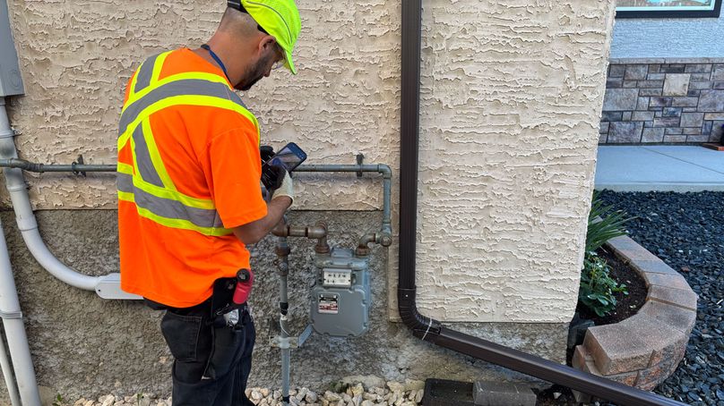 Manitoba Hydro employee inspecting a natural gas meter.