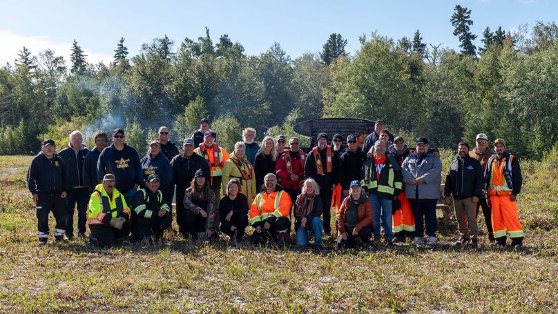 A group photo of Manitoba Hydro board members and staff stand with Chemawawin Cree Nation (CCN) leadership and community members at the Old Post