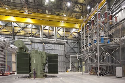 138 kV 125 MVA transformer positioned in the test hall beside a variable-frequency power transformer test system