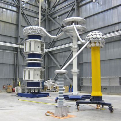 CVT undergoing partial discharge testing using an 800 kV AC resonant test set in the high-voltage hall.