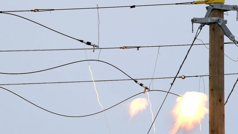 A close-up of implosion sleeves only moments before full detonation, with glowing fuses and orange sparks.
