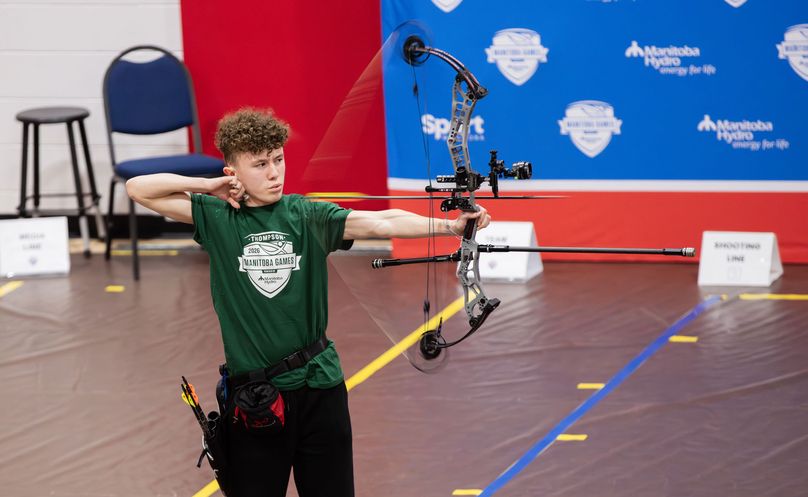 An archer released his bowstring to launch an arrow in competition.