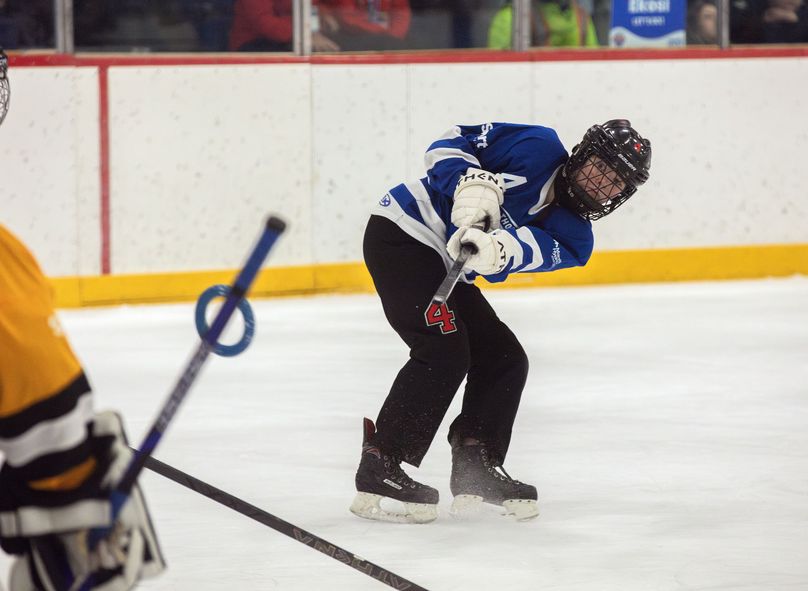 A ringette player fires the ring on net during a game.