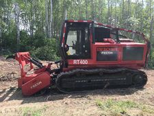 A tracked vehicle with a mulching attachment on the front used to clear vegetation along electrical infrastructure.