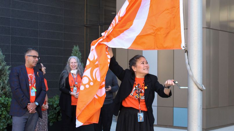 Woman raising orange flag.