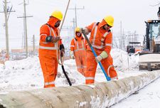 Three Hydro workers preparing to hoist a hydro pole.