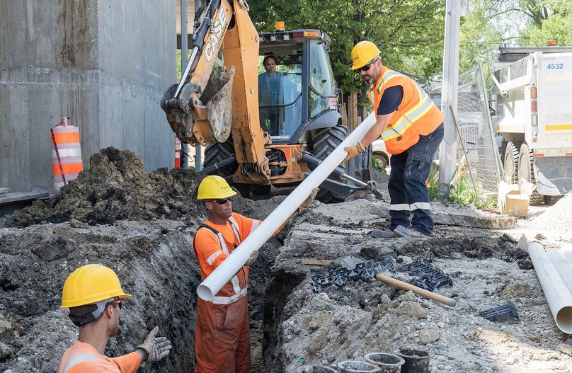 Three Manitoba Hydro employees do excavation work at Osborne Terraces.