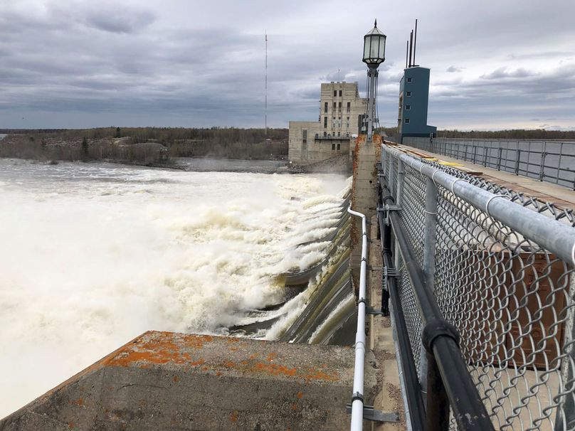 Water surges through all gates of a dam.