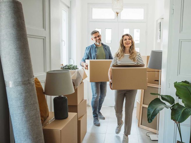 Man and woman carrying boxes