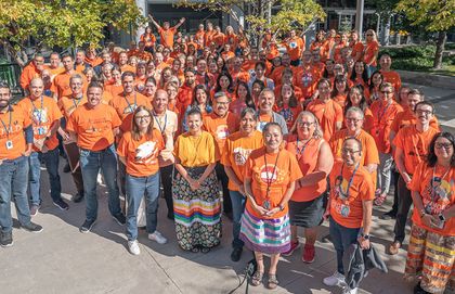 A crowd of Hydro employees wearing orange shirts.