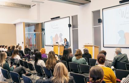 Woman presenting to a group of women.